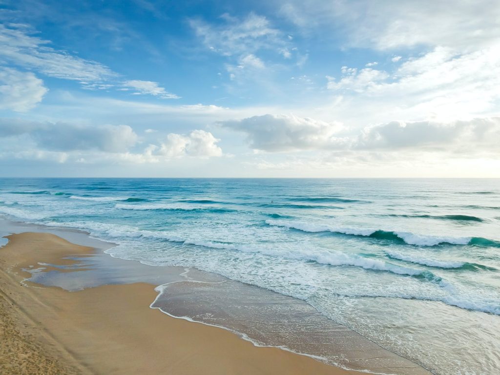 beach under blue and white sky