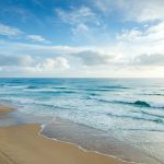 beach under blue and white sky